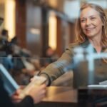 A woman withdraws early retirement funds at bank.